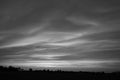Silhouette of landscape against cloudy sky