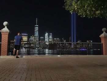 Rear view of man standing at night