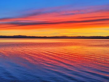 Scenic view of sea against romantic sky at sunset