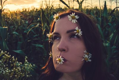 Close-up of beautiful young woman with flowers