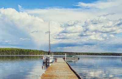 Jetty sailing in lake against sky