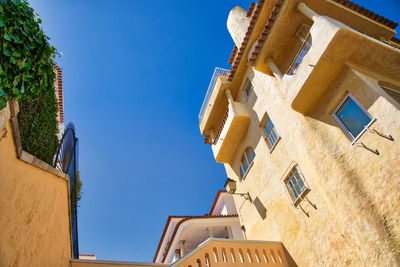 Low angle view of building against clear blue sky