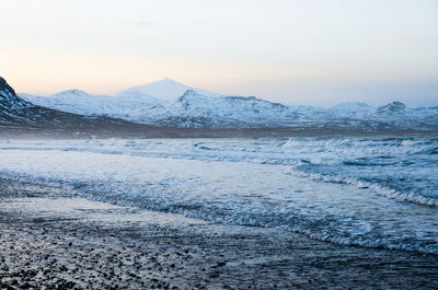 Scenic view of snowcapped mountains against sky during sunset