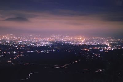 High angle view of illuminated buildings in city at night