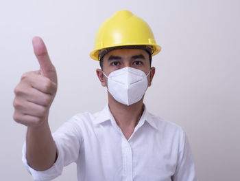 Portrait of man wearing mask against white background