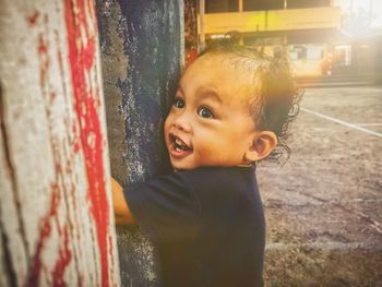 Portrait of cute boy standing outdoors