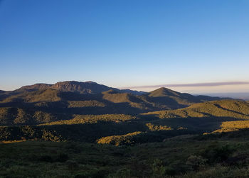 Scenic view of mountains against clear blue sky