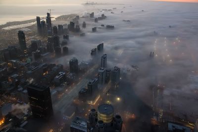 Aerial view of cityscape during foggy weather