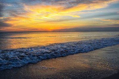 Scenic view of beach against sky during sunset