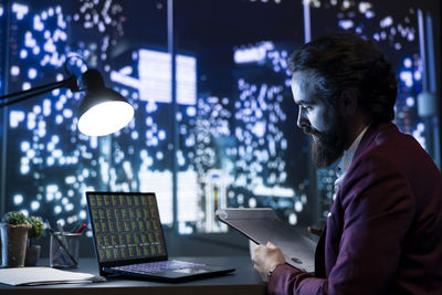 Businesswoman using laptop at office