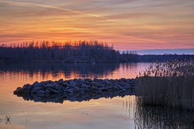 Scenic view of lake against sky during sunset