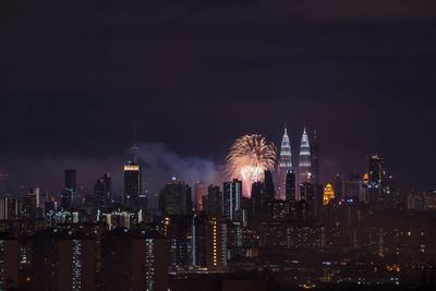 Firework display over city at night