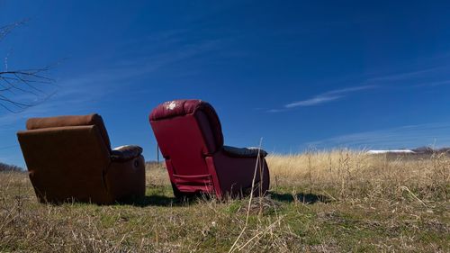 Rear view of two seats on landscape