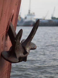 Close-up of rusty boat moored at harbor