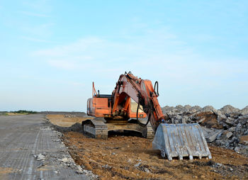 Construction site by road against sky