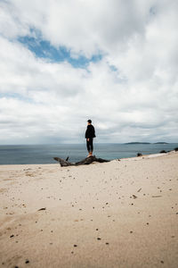 Man standing on beach against sky
