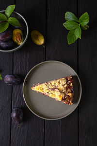 Piece of plum pie on a dark background