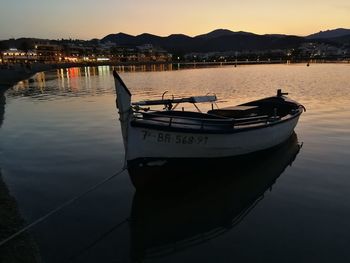 Boats in marina at sunset