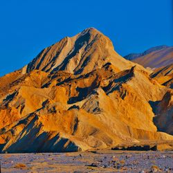 Scenic view of mountain against blue sky