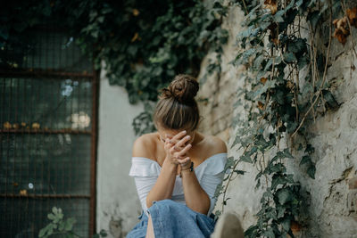 Rear view of woman sitting outdoors