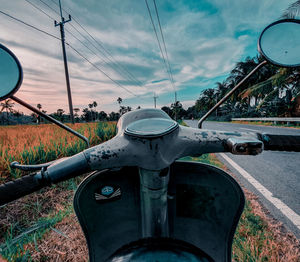 Low angle view of bicycle on field against sky