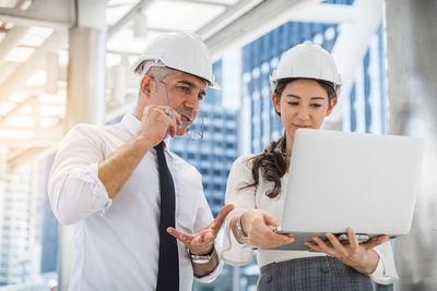 Midsection of man working with mobile phone