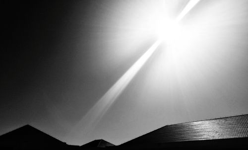 Low angle view of sun shining in sky