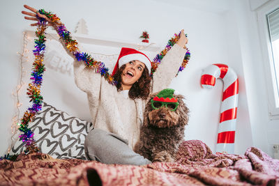 Portrait of woman with dog at christmas 