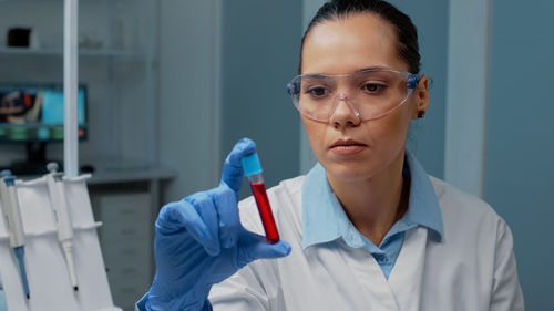 Female scientist holding test tube in lab