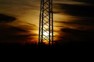 Low angle view of electricity pylon against sky