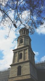 Low angle view of building against cloudy sky