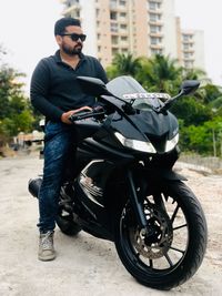 Young man riding motorcycle on street in city