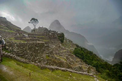 Scenic view of mountain against cloudy sky, machu piccu fog