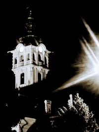 Low angle view of illuminated building against sky at night