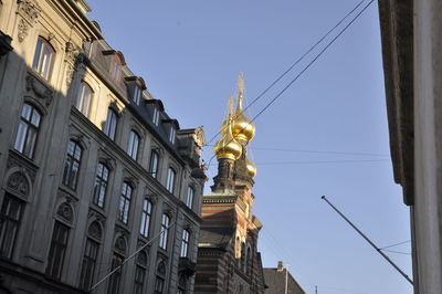 Low angle view of statue against buildings in city