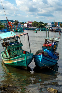 Fishing boats moored at harbor