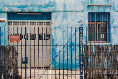 Fence against blue building