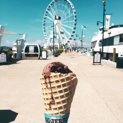 Close-up of ice cream cone at amusement park during summer