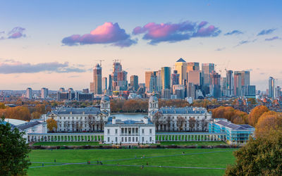 Buildings in city against sky during sunset