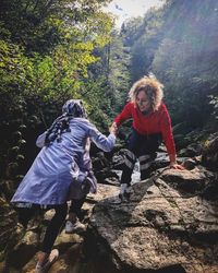 Woman with umbrella on rock