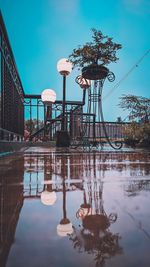 Gazebo by lake against sky in city