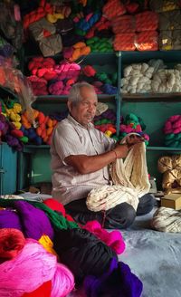 Man selling fabrics at store