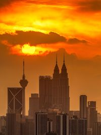 Silhouette buildings against sky during sunset