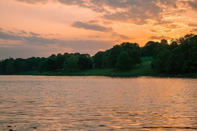 Scenic view of lake against orange sky