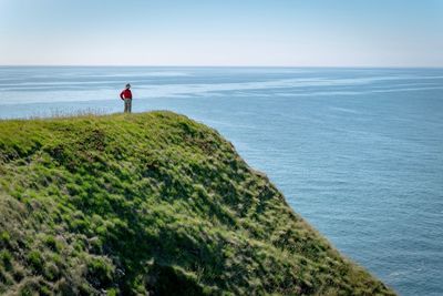 Man looking at sea against sky