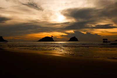 Scenic view of beach against sky during sunset