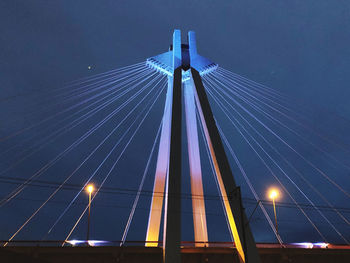 Low angle view of illuminated suspension bridge at night