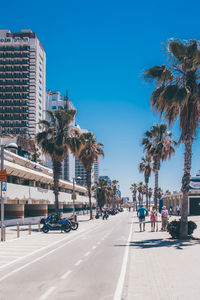 Road in city against clear sky