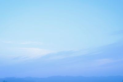 Scenic view of mountains against blue sky