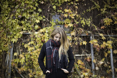 Young woman standing in forest